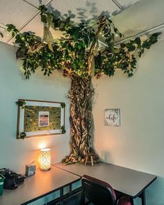 a desk with a tree on it and a lit candle in front of the table