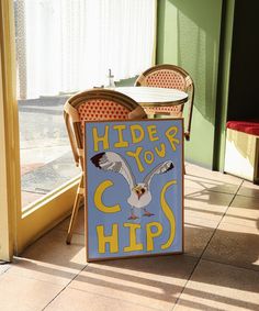 a sign that says hide your hips in front of a table with chairs on it