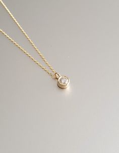 DETAILS * We never use gold plates or gold-filled metals in any of our jewelry. All the metals we use are lead-free, nickel-free, and hypoallergenic. * 0.03 ct Solitaire Pendant Width: 2.5 mm * 0.03 ct Solitaire Pendant Height: 2.5 mm * Chain Length: 18 inches * Chain Type: Dainty Cable * Clasp: Spring Ring * Ready to Ship in 1-3 Business Days * 100% US sourced * 6 Months Warranty * Free returns within 30 days from the order date DIAMOND DETAILS * Gem Stone: Genuine Diamond * Diamond-Cut: Round * Diamond Carat Weight: 0.03 CT - 0.06 CT - 0.15 CT * Diamond Color-Clarity: H Color, SI Clarity * Setting Type: Bezel Setting * 100% US sourced HANDMADE * Handcrafted by our trusted craftsmen with care. * 100% Ethically Sourced. * All processing of the packaging is done by hand.  * The Preparation Minimalist 14k Gold Diamond Necklace With Bezel Setting, Gold 14k Diamond Necklace With Single Diamond, Gold Birthstone Necklace With Bezel Setting, Gold Round Stone Birthstone Necklace, Gold Fine Jewelry Birthstone Necklace, Gold Birthstone Necklace Fine Jewelry, Gold Birthstone Necklace With Round Stone, Gold Round Cut Birthstone Necklace In Fine Jewelry Style, Gold Round Cut Birthstone Necklace Fine Jewelry