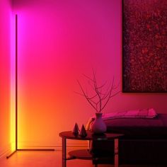 a living room with pink and purple lighting