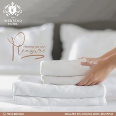 a woman is holding towels on top of a bed with the words hotel you with pleasure written above it