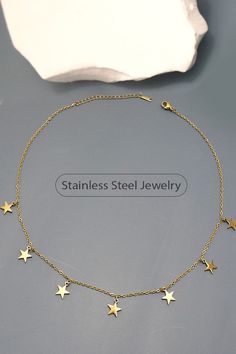 Introducing our Star Necklace, a dazzling piece of jewelry that combines elegance and durability. Made from high-quality stainless steel with a luxurious 18K gold finish, this necklace features delicate star-shaped pendants that are sure to catch the eye. Perfect for any occasion, it's a star-studded addition to any outfit. • Product Details: length: 17.5" Charm size: .4" ext: 3" ext clasp: Lobster Claw Metal finish: Stainless Steel 18K Gold product: Lead & Nickel Compliant anti-tarnish: Tarnish Free, Non-Tarnish Rose Boutique, Star Necklace, Stainless Steel Jewelry, Star Shape, The Eye, Gold Finish, Set Dress, 18k Gold, Stainless Steel