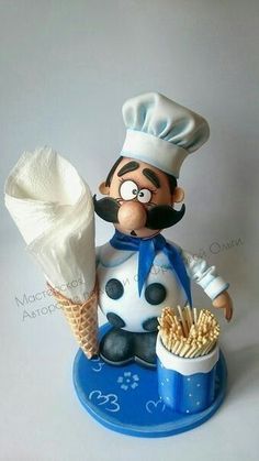 a figurine of a chef holding a pastry and a cup of french fries