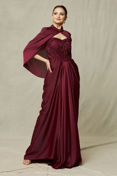 Deep maroon draped padded gown with cutdana, bead, sequin embroidery in floral pattern. Paired with cape.
Components: 2
Pattern: Embroidery
Type Of Work: Cutdana, bead, sequin, floral
Neckline: Gown: Sweetheart neck, Cape: Mandarin collar
Sleeve Type: Gown: Sleeveless, Cape: Flared sleeves
Fabric: Gown: Crepe, Net, Cape: Crepe
Color: Maroon
Other Details: 
Noodle strap on shoulder
Neckline embroidered cape
Occasion: Cocktail - Aza Fashions Cocktail Dress Indian Wedding, Maroon Gowns, Maroon Gown, Western Gowns, Gown With Cape, Noodle Strap, Reception Gowns, Cape For Women, Net Gowns