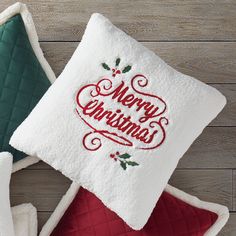 two christmas pillows on top of each other with the words merry christmas written on them