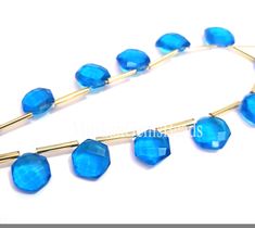 blue glass beaded necklace with gold plated metal bar and long chain, on white background