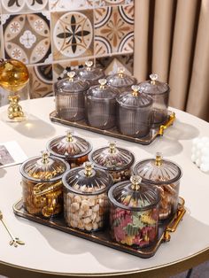 a table topped with lots of different types of candies on top of trays