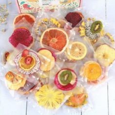 a bunch of fruit is sitting on the table next to a box and some other items