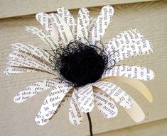 a flower made out of book pages with the word sale written on it