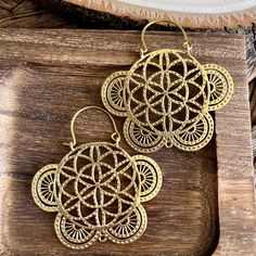 Adorn yourself with the celestial elegance of our Handcrafted Flower of Life Brass Hoop Lightweight Earrings - a perfect blend of sacred geometry and artisanal craftsmanship. Meticulously designed, these brass earrings feature the intricate Flower of Life pattern in a lightweight hoop, adding a touch of divine beauty to your everyday style. 🌸🌀 Key Features: - Handcrafted with precision, creating a pair of lightweight artisanal brass hoop earrings with Flower of Life design. - High-quality brass construction ensures enduring shine and durability. - Flower of Life pattern, symbolizing universal harmony and interconnectedness. - Lightweight and comfortable, perfect for daily wear with a touch of sacred elegance. Material: High quality brass  Width: 2 inches   Length: 2 inches. 🌟 Product De Flower Of Life Pattern, Sacred Geometry Mandala, Mandala Jewelry, Brass Hoop Earrings, Seed Of Life, Golden Earrings, Brass Hoops, Flower Of Life, Light Weight Earrings