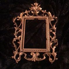 an ornate gold framed mirror on a black background