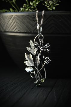 ITEM DESCRIPTION: The size H 5 cm x W 3 cm (2 x 1 1/3 inch). Weight - 5 g. You can buy it with a silver chain or without it. Even simple plants look very elegant. I made one of sterling silver, pretty green tourmaline, and peridot. This unique botanical jewelry looks like a real treasure of wild forest. It is really worthy of being in your precious collection. Expect many compliments on this! This handmade necklace will come to you in a gift box - ready for gifting. The parcel will be sent durin Silver Engraved Nature-inspired Necklace, Nature-inspired Engraved Silver Jewelry, Green Sterling Silver Flower Pendant Jewelry, Silver Nature-inspired Round Pendant Jewelry, Silver Round Pendant Jewelry With Nature-inspired Style, Nature-inspired Engraved Flower Pendant Necklace, Nature-inspired Metal Pendant Necklace, Nature-inspired Sterling Silver Pendant Jewelry, Nature-inspired Sterling Silver Pendant Necklace