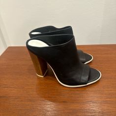 New. Never Worn With Price Tag. Soft Leather With Wooden Heel. $80 Or Best Offer. Black Mules With Wooden Heel For Formal Occasions, Black Formal Mules With Wooden Heel, Casual Leather Heels With 4-inch Heel, Designer Black Mules With Sculpted Heel, Black Leather Mules With Stacked Heel, Black Leather Mules With Sculpted Heel, Black Mules With Wooden Heel For Work, Modern Black Mules With 4-inch Heel, Designer Leather Mules With Stacked Heel