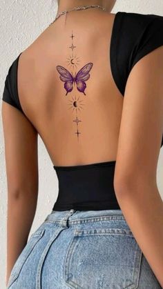 the back of a woman's body with a butterfly tattoo on her lower back