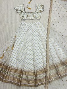 Ivory Designer Fully Customised Lehenga Choli Specification Lehenga Lehenga Fabric : Banarasi Gerogette silk Lehenga Closer: Drawstring, Attached Tussle  Flair: 3.5 Meter Inner: Cotton Skirt Style: Customized  Blouse Blouse Fabric: Raw Silk Blouse Work: Sequins, Kasab, Zardosi Blouse Neck: Fully Customized  Dupatta Dupatta Finish Type: Heavy Lace, Sequins, Kasab, Zardosi Dupatta Fabric: Soft Net Package Contain: Lehenga, Blouse and Dupatta, Drawstring, Tussle  Our products are 100% authentic and Elegant Off-white Lehenga For Festive Occasions, Cream Dress With Cutdana For Diwali, Elegant Cream Lehenga For Navratri, Cream Dress For Navratri Reception, White Cutdana Set For Reception, Bollywood Style Cream Dress With Sheer Dupatta, Festive Off White Sharara For Reception, Festive Beige Cutdana Dress, Cream Dress With Dupatta For Navratri