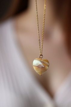 This delicate unique necklace was made of natural mother of pearl beige heart pendnat and high quality gold tone stainless steel chain with gold tone lobster claw. The chain is from lead & nickel free metal. Perfect jewelry for everyday wear and a great gift for someone special! The length of necklace is 45 cm or 17.7 inches. Other necklaces of my shop you can see here: https://www.etsy.com/shop/NaTavelli?section_id=14843046&ref=shopsection_leftnav_5 Thanks for a visit. Jade Pendant Necklaces For Crafting, Jade Necklaces With Round Beads For Gifts, Elegant Round Pendant Charm Necklaces For Healing, Jade Necklace With Round Beads For Gifts, Elegant Round Pendant Charm Necklace For Healing, Jade Bead Necklace For Gifts, Natural Stones Round Necklace For Her, Natural Stones Necklace For Her, Natural Stone Necklaces As Gift For Her