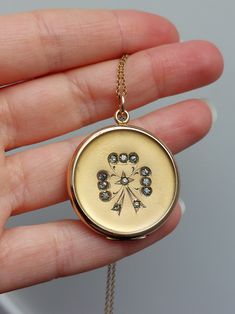 "Introducing an exquisite antique locket, a timeless piece that embodies the grace and charm of the Edwardian era. At the front of the locket is a graceful bow design, decorated with glass rhinestones, adding a subtle sparkle and a touch of femininity and sophistication. The back is plain and could be engraved. Details: The locket is from the 1910s. It is not stamped for gold content and likely made of gold filled. Inside the maker marks are present on the two rings \"J.M.F. & Co\". Condition: The locket has no dent and is in excellent antique condition. It opens from the top, and shuts tightly with a snap. This listing is for the locket only without a chain. Measurements: -Locket diameter : 31mm / 1 1/4\" -Locket height including the jump ring: 40mm / 1 9/16\" Please note that I don't acc Luxury Antique Gold Locket Necklace, Antique Charms Locket Necklace For Wedding, Antique Round Necklace With Diamond Accents, Elegant Antique Gold Necklaces With Charms, Vintage Diamond Medallion Jewelry, Victorian Diamond Medallion Jewelry, Victorian Medallion Diamond Jewelry, Gold Engraved Jewelry For Vintage Events, Vintage Charms Jewelry For Wedding