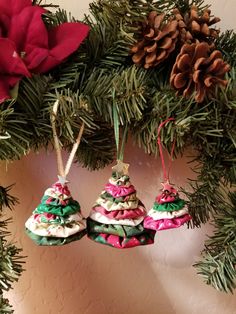 three ornaments hanging from a christmas tree