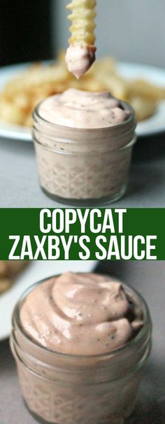 two jars filled with food sitting on top of a table next to some cookies and dipping sauce