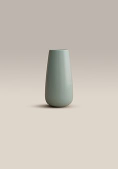 a light blue vase sitting on top of a table