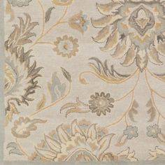 an area rug with various flowers and leaves on it's side, in neutral colors