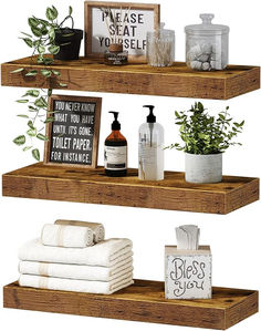 three wooden shelves with towels, soaps and plants