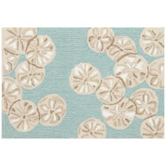 a blue rug with sand dollars on it