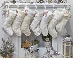 christmas stockings hanging from a mantel decorated with ornaments