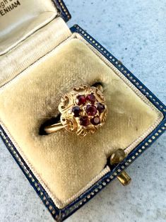 This is a vintage 9ct Gold Garnet Cluster Ring. 7 vibrant garnets create a lovely cluster and are set in a decorative yellow gold setting. Ring size N  Weight: 2.69 grams approximately. The ring is marked with full London hallmarks, 9. 375 for 9ct Gold and dates to 1967. Please note all sizes and measurements are approximate. Comes with box. Box may differ from that in photos. As most of our pieces are vintage finds they only come in one size. However if you require your ring to be sized so it's Yellow Gold Setting, Cluster Ring, Vintage 1960s, Ring Verlobung, Vintage Finds, Uk Shop, Etsy Store, Garnet, Dates