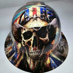 a helmet with an image of a skull wearing glasses and a patriotic hat on it