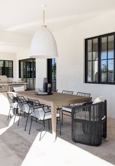 an outdoor dining area with chairs and table