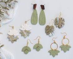 Each earring is meticulously crafted, capturing the intricate details of nature, giving them a sense of unique beauty. Each earring has a peaceful sage color that gives a calming earthy feel. Very lightweight with lots of movement!  Drop length ranges from 1 3/4" to 2 1/4"  Each pair is a one-of-a-kind, handmade with love which may include variations and imperfections.  Please check out our shop for more styles.  Follow us on instagram at @fernie.and.co Minimalist Handmade Drop Earrings, Botanical Style Jewelry With Matching Dangle Earrings, Nature-inspired Everyday Jewelry With Matching Earrings, Nature-inspired Dangle Earrings For Everyday Wear, Nature-inspired Everyday Pierced Earrings, Nature-inspired Earrings For Everyday, Nature-inspired Dangle Earrings, Green Nature-inspired Everyday Jewelry, Nature-inspired Single Earring As Gift