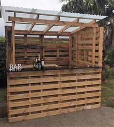 an outdoor bar made out of pallets and wood