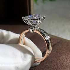 an engagement ring on top of a white cloth