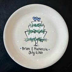 a white plate with a wedding cake on the front and blue hearts on the back