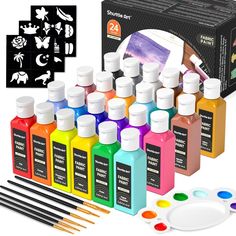 an assortment of paint bottles and brushes in front of a box with other paints on it