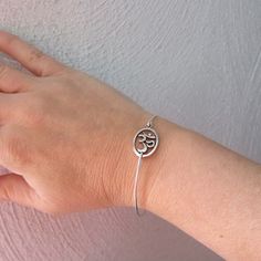 Silver Om Bracelet - A silver tone Om sign has been transformed into an Om bangle bracelet with a silver filled band for you to wear. I can also make this Om bracelet with a sterling silver band for an additional $10. If you would like this option for your Om symbol jewelry, select from options when ordering your Chakra bracelet. This Om stacking bangle looks great together with others from my collection as you can see from the last picture. Have fun stacking your yoga bangle bracelet with other Adjustable Silver Jubilee Bracelet Bangle, Nickel-free Silver Spiritual Bangle, Adjustable Silver Spiritual Bracelets, Silver Adjustable Spiritual Bracelets, Adjustable Silver Spiritual Bracelet, Adjustable Symbolic Bangle Bracelet, Adjustable Symbolic Bangle, Adjustable Sterling Silver Symbolic Bracelet, Adjustable Symbolic Sterling Silver Bracelet