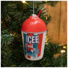 an ornament hanging from a christmas tree with ice cream in the shape of a fire extinguisher