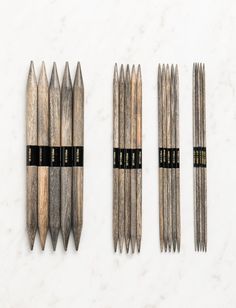 four different types of sticks with black labels on them and one is made out of wood