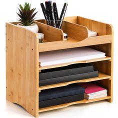 a wooden desk organizer with pens, papers and pencils in it's holder