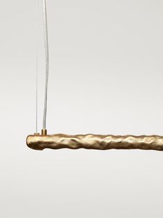 a piece of metal hanging from a string