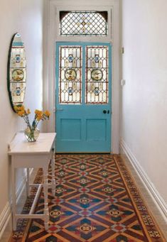 an entryway with a blue door and stained glass windows