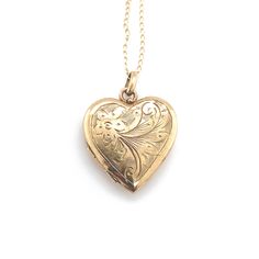 All of our jewelry is guaranteed authentic by our Graduate Gemologist of the Gemological Institute of America (GIA). 9k Yellow Gold Heart Shaped Locket with Engraved Flowers (#J6431) 9k yellow gold heart shaped locket on chain. The locket measures 7/8" long with bail by 5/8" wide and has pretty engraved flower design. The pendant includes a new 19" 14k yellow gold chain. The necklace weighs 2.12 dwt. The locket has English hallmarks for Birmingham by B and S, possibly made in 1987. Charming! SKU Engraved Flower, Yellow Gold Chain, Heart Of Gold, Locket, Flower Designs, Heart Shapes, Jewelry Necklace Pendant, Yellow Gold, Jewelry Necklaces