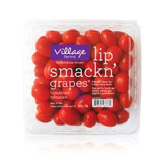 small tomatoes in a plastic container on a white background with the words village farm lip smack'grapes