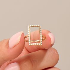 Rectangle Statement Ring 14k Real Solid Gold 14k 10k 18k Real Solid Gold Open Pave Rectangle Statement Ring is available in Yellow White Rose Gold. Make a statement with this dainty and versatile ring, suitable for everyday wear or as an accent piece for special events. It complements any outfit and effortlessly enhances your style.  Ring Details  ❥ 14k Yellow Gold(also in 10k,18k)  ❥ Gold Color Options; Solid Yellow Gold, White Gold, Rose Gold  ❥ Band Width: 1.35 mm  ❥ Top Width: 17.65x10.40mm Gold Rectangular Minimalist Diamond Ring, Minimalist Rectangular Diamond Ring In Yellow Gold, Gold Minimalist Rectangular Diamond Ring, Modern Rectangular Diamond Ring With Single Cut Diamonds, Minimalist Rectangular Yellow Gold Diamond Ring, Gold Rectangular Brilliant Cut Diamond Ring, Gold Cubic Zirconia Rectangular Rings, Rectangular Gold Cubic Zirconia Rings, Fine Jewelry Rectangular Yellow Gold Diamond Ring