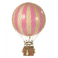 a hot air balloon with pink and white stripes on it's side, sitting in a wicker basket