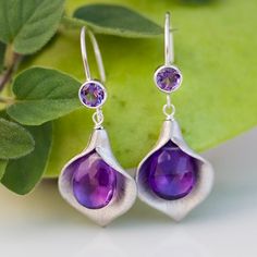 "Purple Amethyst Flower Earrings, February Birthstone, Calla Lily Jewelry, Woodland Jewelry, Nature-Inspired Earrings, Gift for Mom Our timeless Calla Lilly birthstone earrings are a Delezhen best seller! Simple and elegant, these earrings feature a silver or gold plated calla lily with a wire-wrapped stone of your choice tucked inside and a matching stud or hook top. Available in 6 different stone & color options, these earrings make ideal gifts! H O W ∙ T O ∙ O R D E R 1st DROP DOWN menu * Elegant Purple Sterling Silver Flower Earrings, Elegant Purple Teardrop Flower Earrings, Calla Lily Jewelry, Lily Jewelry, February Birthstone Jewelry, Bezel Set Earrings, Amethyst Flower, Woodland Jewelry, Set Earrings