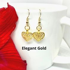 Are you looking for an elegant piece of jewelry that is durable enough to wear everyday? These dangle heart earrings are the perfect accessory! Made from high quality metal alloy (lead and nickel free), these unique and intricately detailed earrings are stylish in their simplicity and make a perfect gift for yourself or a friend! Available in silver or gold color. Dangle length is approximately 1-inch Valentines Earrings, Elegant Earrings, Heart Jewelry, Heart Earrings, 1 Inch, Gold Color, Perfect Gift, High Quality, Silver