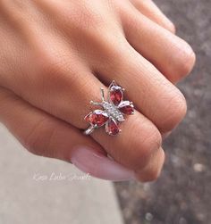 Garnet CZ butterfly silver ring, clear - Red - butterfly ring, silver ring, promise ring - 925 sterling silver Height: 16.0mm Width: 17.0mm Shank Width: 1.7mm Stone Material: Garnet CZ and White Cubic Zirconia Center Stone Size: 7.0mm x 5.0mm & 6.0mm x 4.0mm Stone Shape: Pear and Round Center Stone Carat Weight: 0.71 ct. & 0.39 ct. Number of CZ Stones: 8 Stone Setting: Prong Metal: 925 Sterling Silver Plating: Rhodium Finish: High Polish simply stunning. High Polished, solid 925 sterling silver. Rhodium plated to prevent tarnishing. TARNISH FREE Rhodium plated to avoid tarnishing Nothing but the best from my custom jewelry store. Email me if you have any questions. Elegant Cubic Zirconia Butterfly Ring Gift, Elegant Butterfly Ring With Cubic Zirconia For Gift, Elegant Butterfly Ring Cubic Zirconia Gift, Butterfly-shaped Cubic Zirconia Wedding Rings, Formal Butterfly-shaped Cubic Zirconia Rings, Butterfly Cubic Zirconia Wedding Rings, Butterfly Shaped Diamond Jewelry For Anniversary, Diamond Butterfly Jewelry For Anniversary, Fine Jewelry Butterfly Shape For Wedding