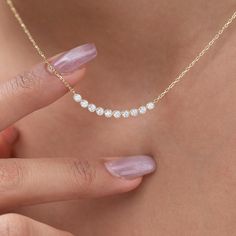 Elevate your style with our dainty 14k Curved Bar Diamond Necklace. This minimalist and handcrafted piece features a delicate bar pendant adorned with sparkling diamonds, making it the perfect wedding gift for her. Embrace the elegance and timeless beauty of this handmade diamond jewelry. Order now and make a statement of sophistication! Alternatively, choose from our options of natural, lab-grown diamonds or dazzling moissanites at three different price points to fit your unique preferences and budget. Please check below to see specifications of each stone option. All our pieces come with Azalea Certification and Warranty document.  Independent appraisals cost an additional $60. All pieces over $2,000 come with free appraisal. M A T E R I A L & L E N G T H Available in 14k Yellow Gold, 14 14k Gold Bar Necklace For Anniversary, Diamond Necklace Designs Unique, Minimalist Diamond Necklace, Diamond Birthday, Dainty Bar Necklace, Necklace Bar, Diamond Bar Necklace, Diamond Necklace Designs, Curved Bar